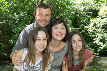 Cute family outdoor with parents and two girls