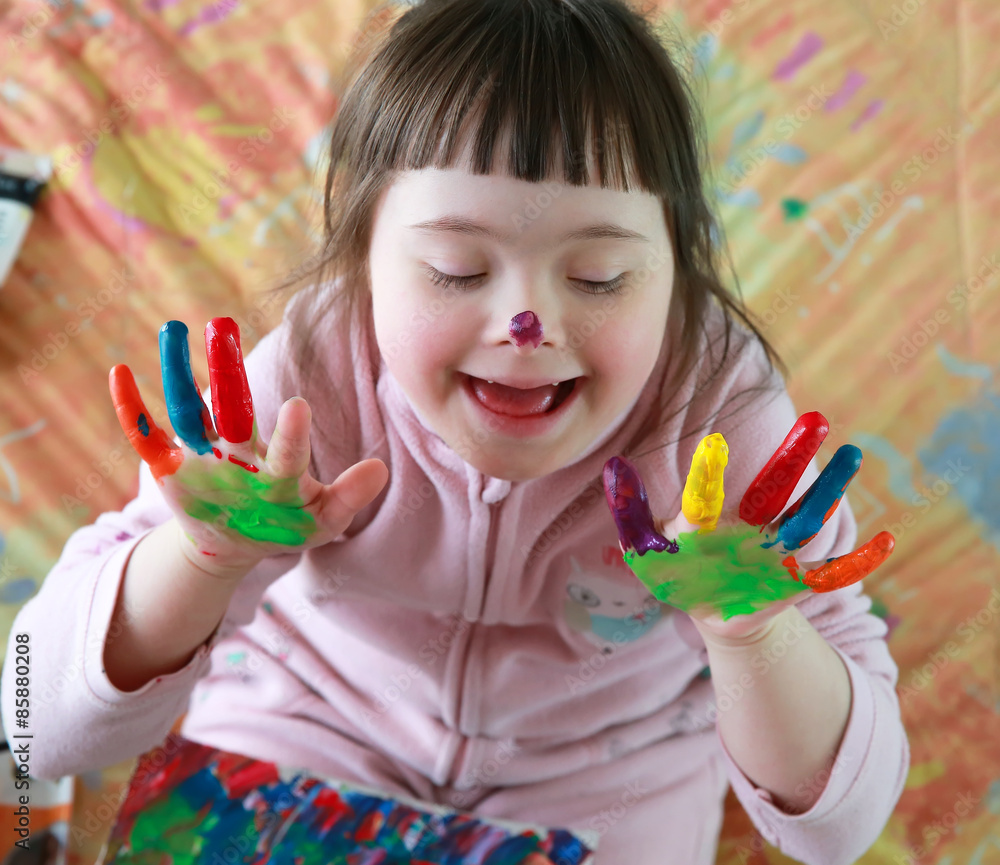 Wall mural Cute little girl with painted hands