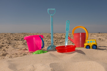 Fototapeta na wymiar Colorful beach toys under blue sky on summertime