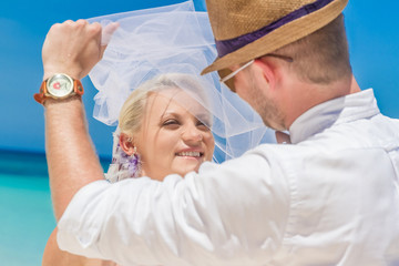 Obraz premium bride and groom enjoying beach wedding in tropics, on wedding ar