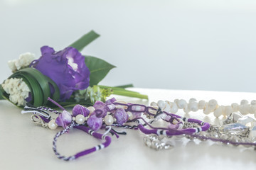 violet bracelets and groom flowers isolated over white
