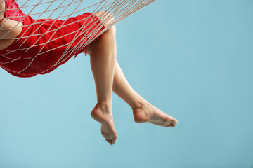 Close-up on the legs of woman lying in a hammock