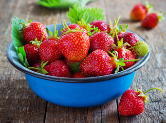 fresh juicy organic strawberries in an old metal bowl