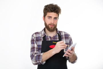 a craftsman planning and writing something on the notebook