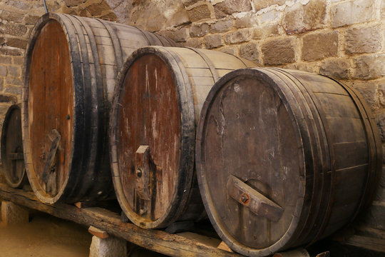four cider or wine barells in a basement 