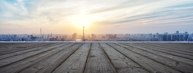 Panoramic skyline and buildings with empty wooden board
