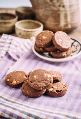 Obraz na płótnie Canvas Chocolate and hazelnuts cookies on cloth