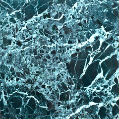 The turquoise surface of the marble in the background