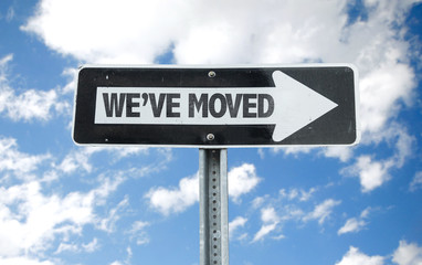 We've Moved direction sign with sky background