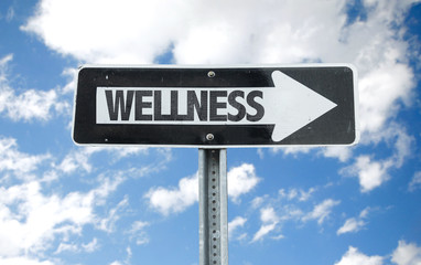 Wellness direction sign with sky background