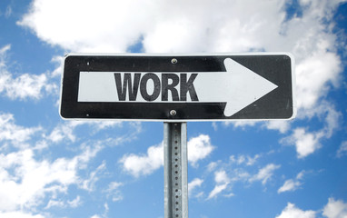 Work direction sign with sky background