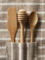 Wooden spoon and fork on pattern towel background