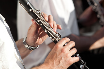  Human hands playing a clarinet closeup - obrazy, fototapety, plakaty