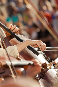 Hands girls playing the cello in the orchestra