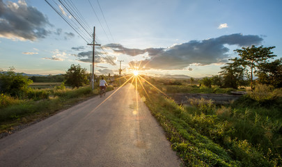 Fototapeta na wymiar Sunset on the road with sun flare