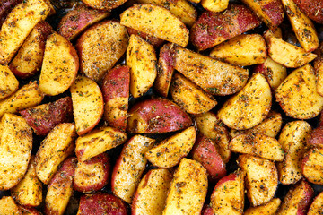 Roasted potatoes with rosemary and spices. Ready to cook Background, texture.