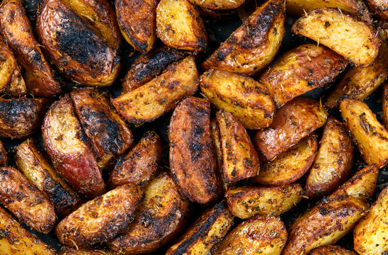 Roasted potatoes with rosemary and spices. Ready to eat. Background, texture