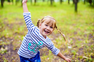 little happy girl playing in the park, baby laughing and having fun