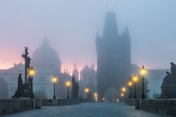 Fototapeta na wymiar Charles Bridge in Prague at sunrise at morning in fog