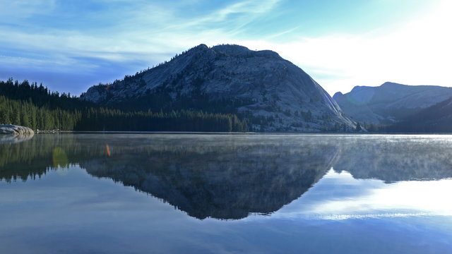  Time lapse footage with zoom out motion of sunrise at reflective lake along Tioga Pass in Yosemite National Park, California