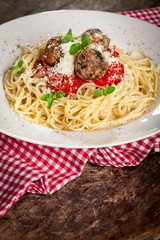 Spahetti with tomato sauce ,meatballs  and grated parmesan