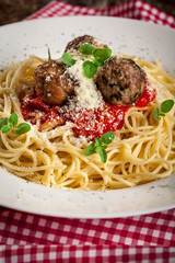 Spahetti with tomato sauce ,meatballs  and grated parmesan