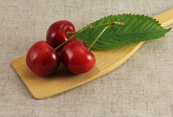 Abstract view cherry on wooden spatula