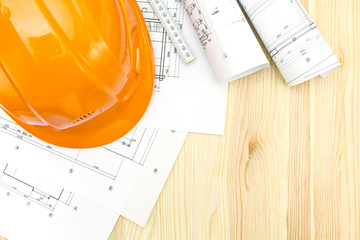 contractor workplace with blueprints and helmet