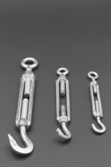 Screw tensioner hook and eyelet