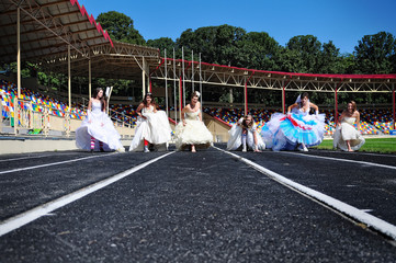 funny brides  on the treadmill outdoors on the stadium