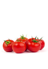Fresh tomatoes with green leaves isolated on white background