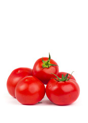 Fresh tomatoes with green leaves isolated on white background