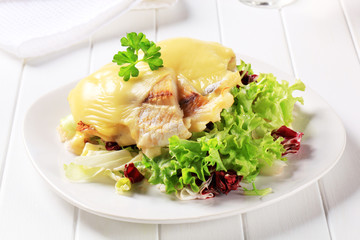 Cheese topped fish fillets with salad