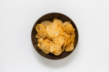Potato Chips in Bowl on white background.