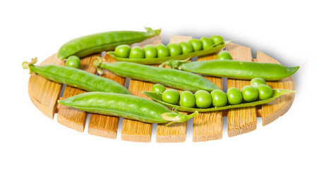 Pods of peas on bamboo small board