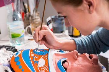 Young Woman Painting Clay Mask