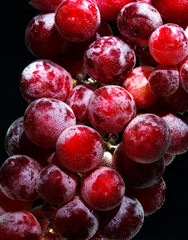 Red grapes with bubbles floating in the water 