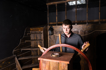 Portrait of Young Man Navigating Wooden Ship © kolotype