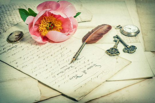Old handwritings, antique feather pen, keys, pocket watch and pi