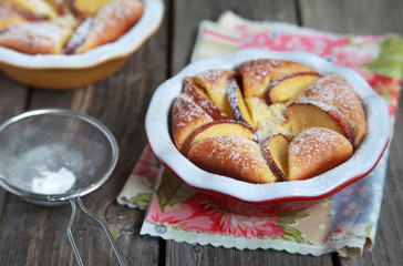 Homemade cottage cheese pie with peaches on wooden table 