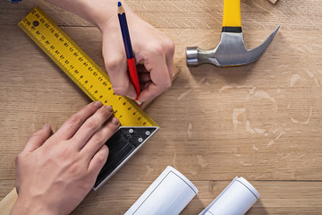 hands of joiner drawing with pencil