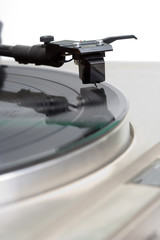Retro Turntable – Vinyl record album playing on a retro turntable.