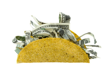 Shredded Money Taco Concept – A crispy taco shell filled with shredded money. Concept for the price of food, expensive eating, and more. Isolated on white with clipping path.