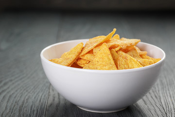 tortilla chips in white bowl on wooden table