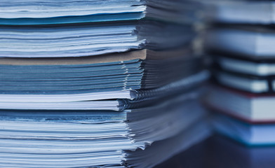 Accounting and taxes. Large pile of magazine and books