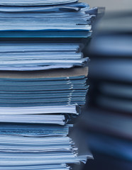 Accounting and taxes. Large pile of magazine and books