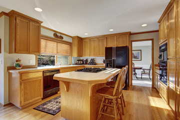 Classic kitchen with hardwood floor and island.