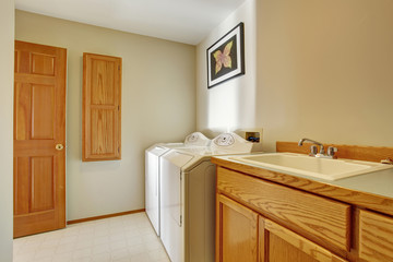 classic laundry room with tile floor.