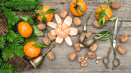 Christmas decoration with tangerine fruits and walnuts