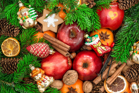 Christmas ornaments and decorations. Apples, mandarin fruits, wa